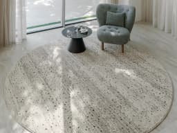 Zen Ashton Round carpet in beige, shown in a lifestyle top view