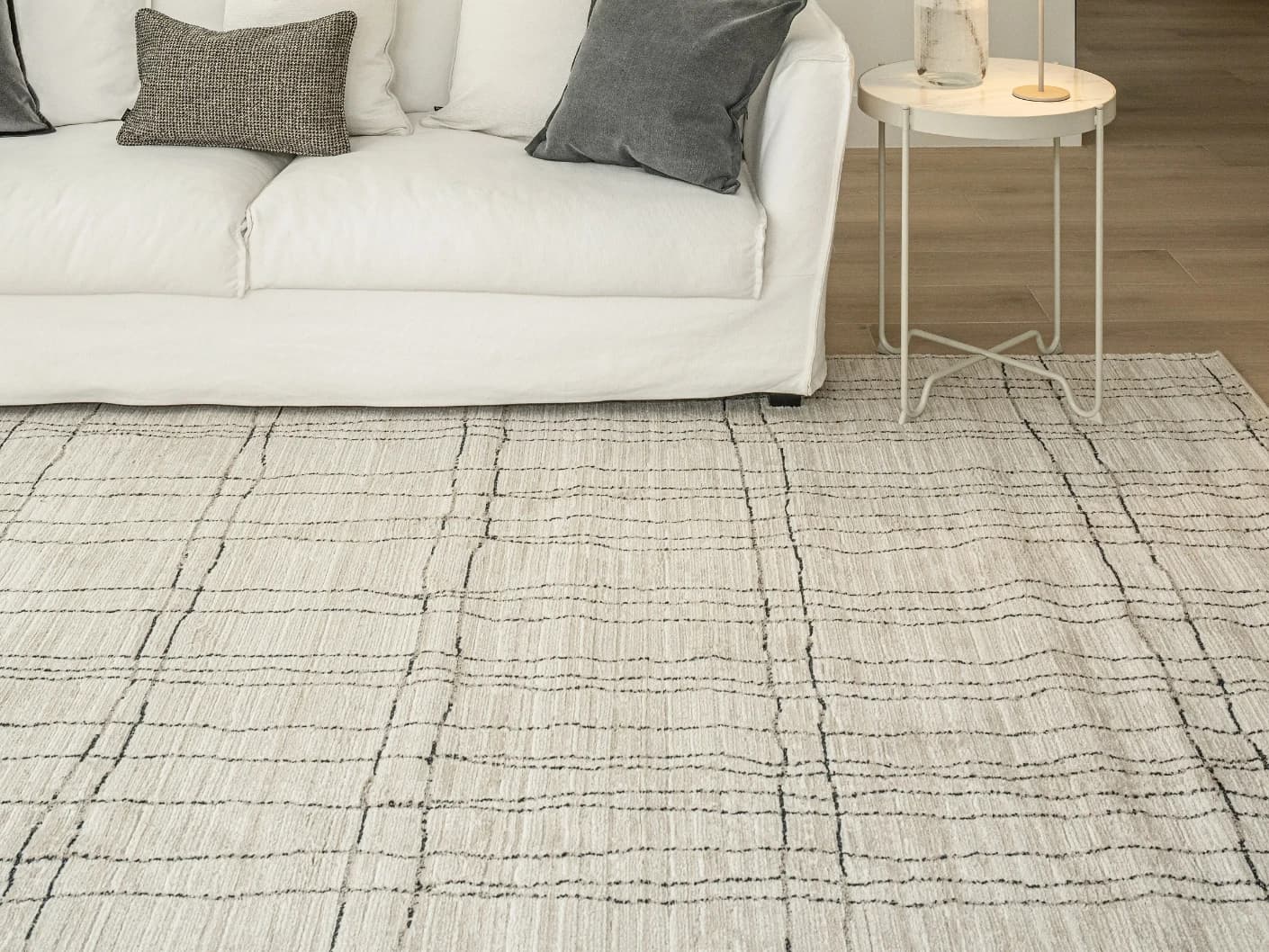 Zen Bianca Round carpet in charcoal and beige, shown in a lifestyle front view as image 4