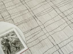 Zen Bianca Round carpet in charcoal and beige, shown in a lifestyle front view