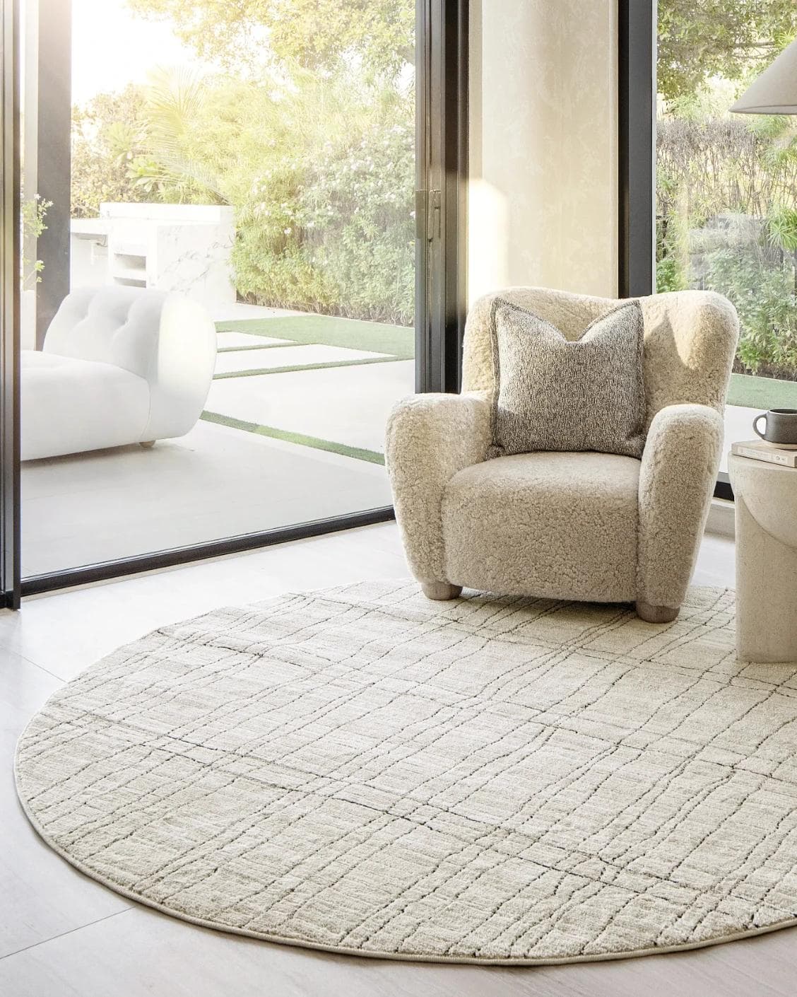 Zen Bianca Round carpet in charcoal and beige, shown in a lifestyle front view as image 4