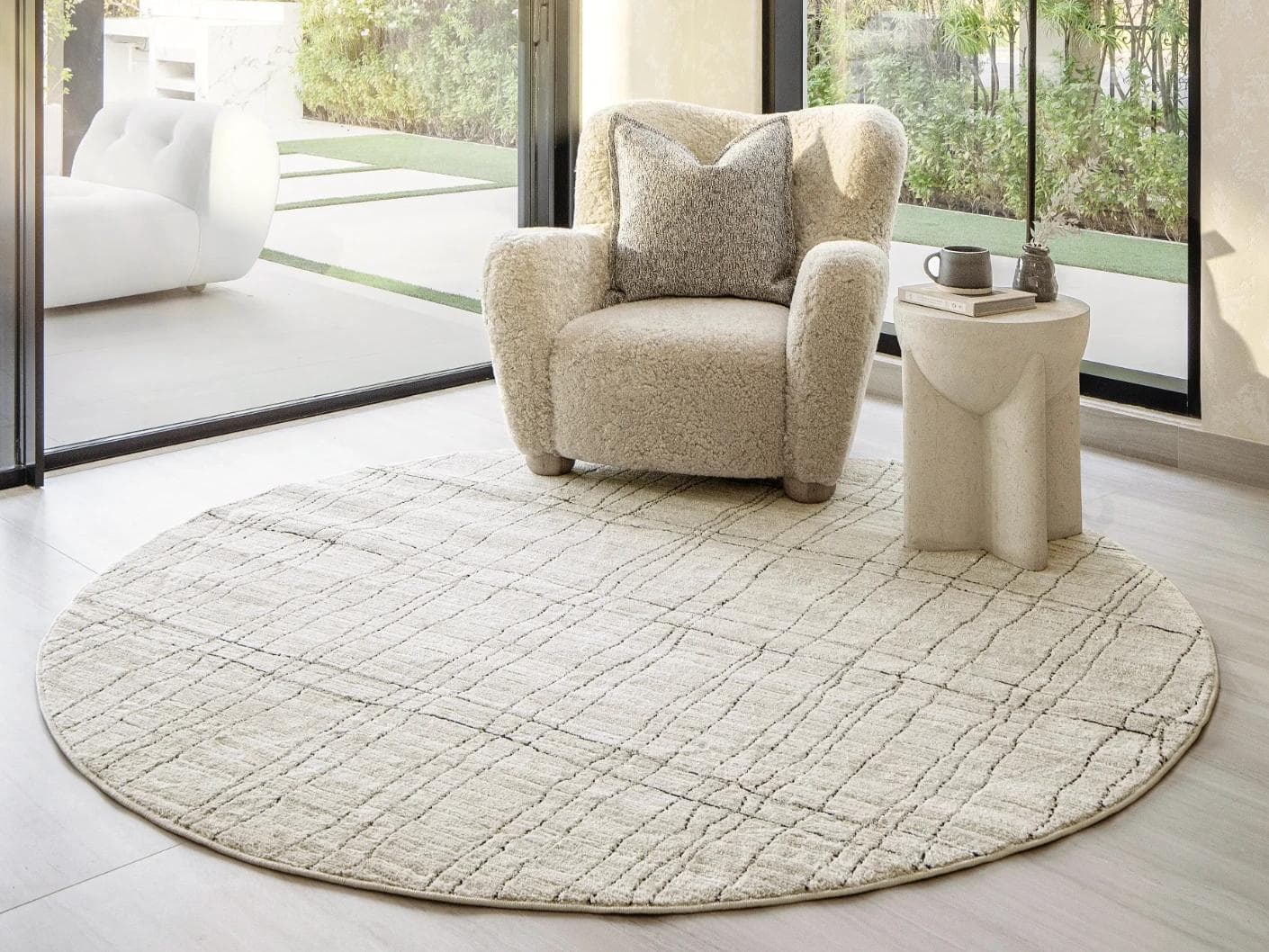 Zen Bianca Round carpet in charcoal and beige, shown in a lifestyle front view as image 4