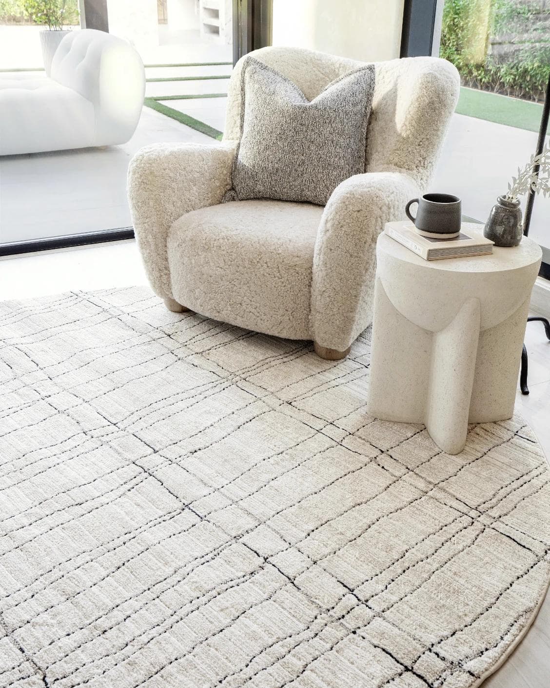Zen Bianca Round carpet in charcoal and beige, shown in a lifestyle right view as image 5
