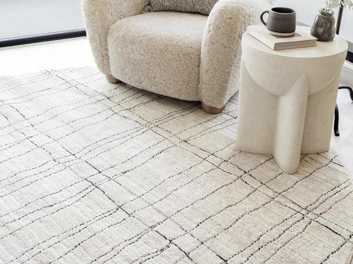 Zen Bianca Round carpet in charcoal and beige, shown in a lifestyle right view as image 5