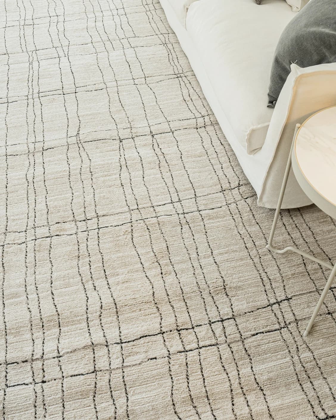 Zen Bianca carpet in charcoal and beige, shown in a lifestyle top view as image 12