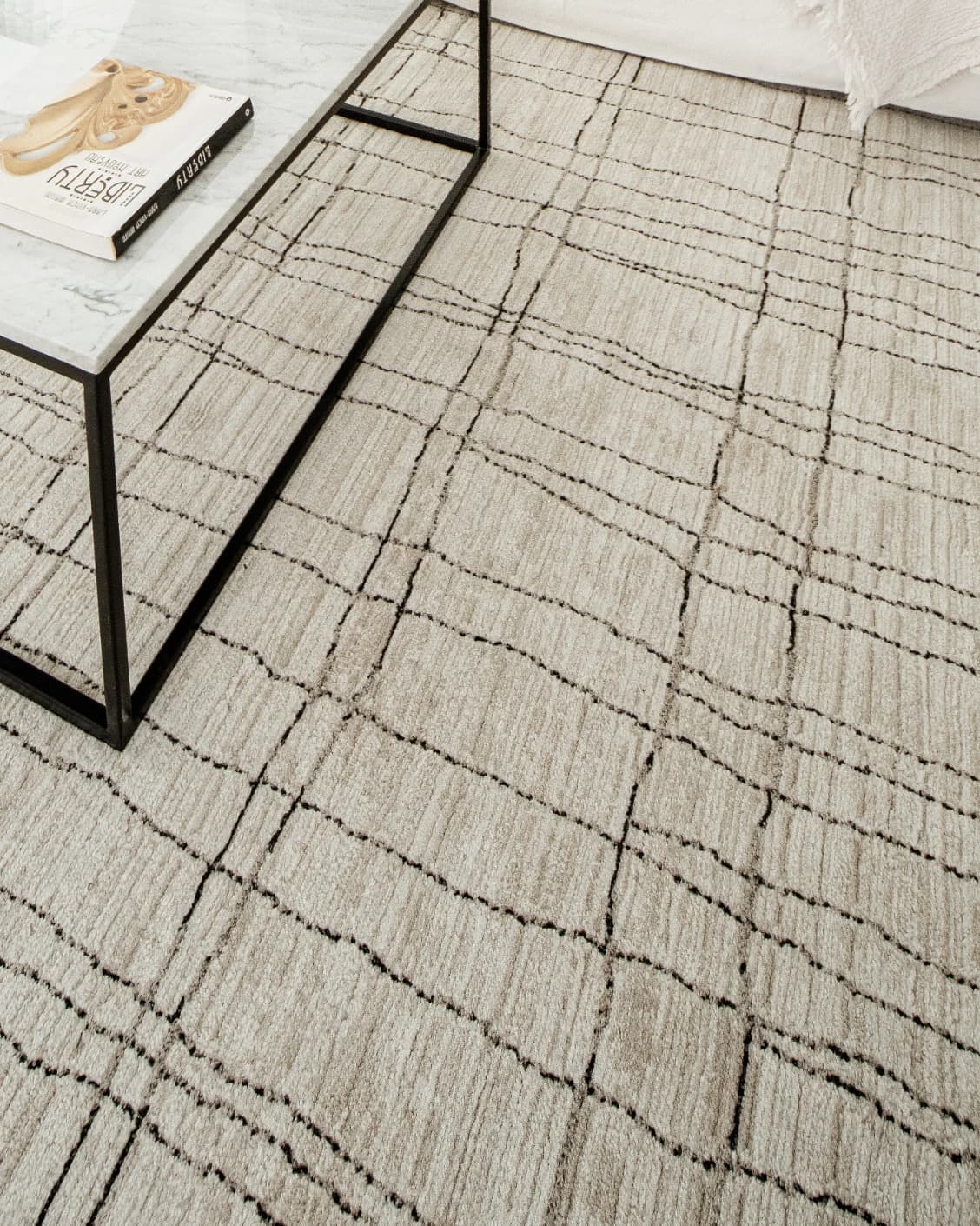 Zen Bianca carpet in charcoal and beige, shown in a lifestyle top view as image 14