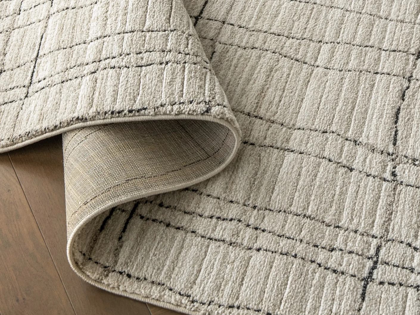 Zen Bianca carpets in charcoal and beige, shown in a product close-up view