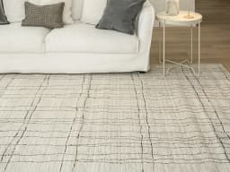 Zen Bianca carpet in charcoal and beige, shown in a lifestyle front view