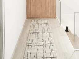 Zen Bianca Runners carpet in charcoal and beige, shown in a lifestyle front view
