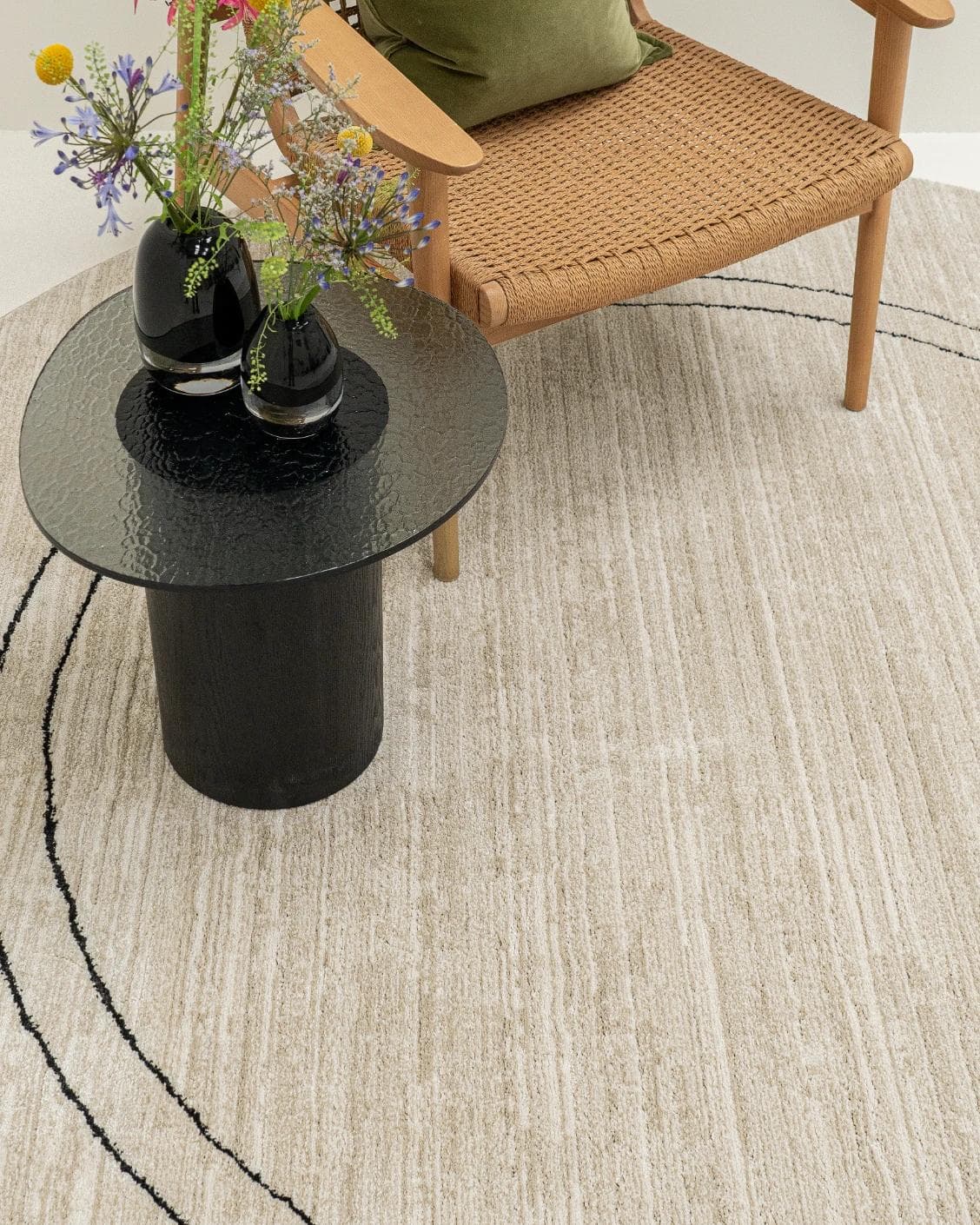 Zen Colin Round carpet in black and beige, shown in a lifestyle top view as image 4