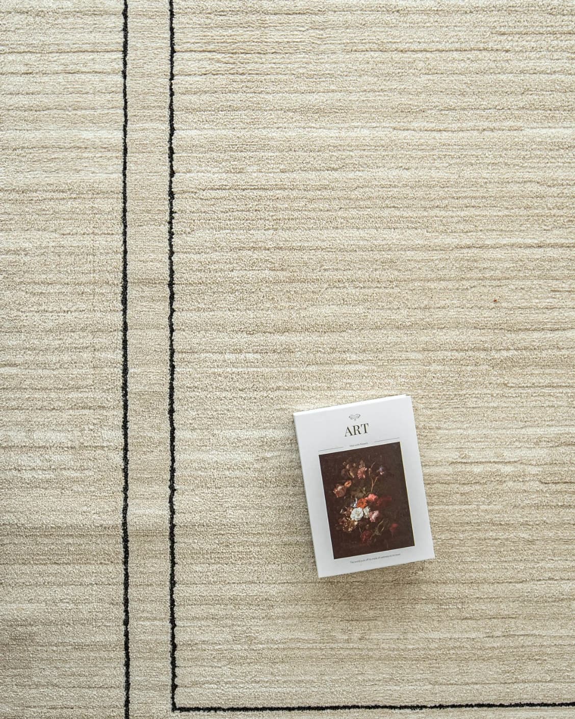 Zen Colin carpet in black and beige, shown in a lifestyle top view as image 9