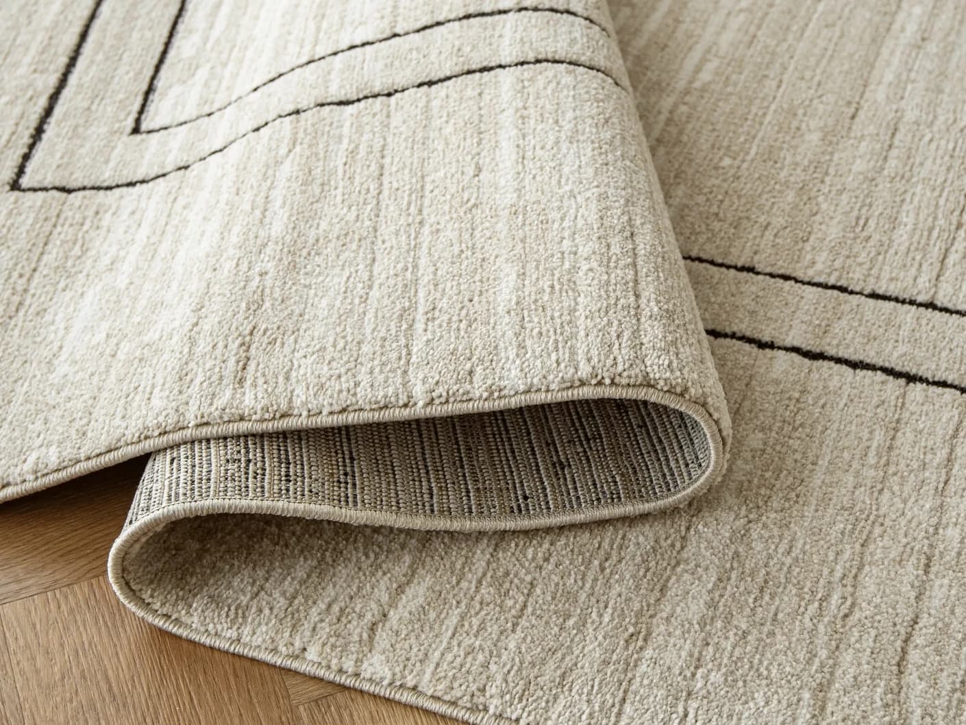 Zen Colin carpets in black and beige, shown in a product close-up view