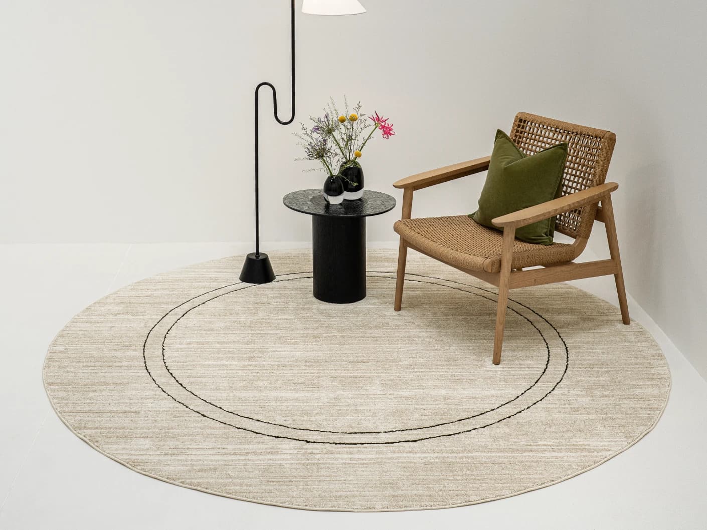 Zen Colin Round carpet in black and beige, shown in a lifestyle