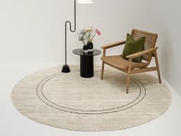 Zen Colin Round carpet in black and beige, shown in a lifestyle