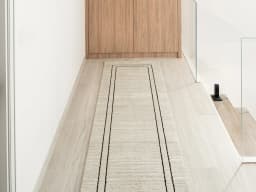 Zen Colin Runners carpet in black and beige, shown in a lifestyle front view