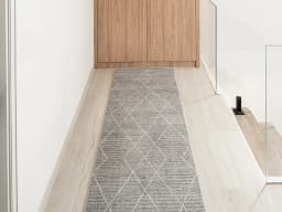 Zen Dune Runners carpet in grey and off white, shown in a lifestyle front view