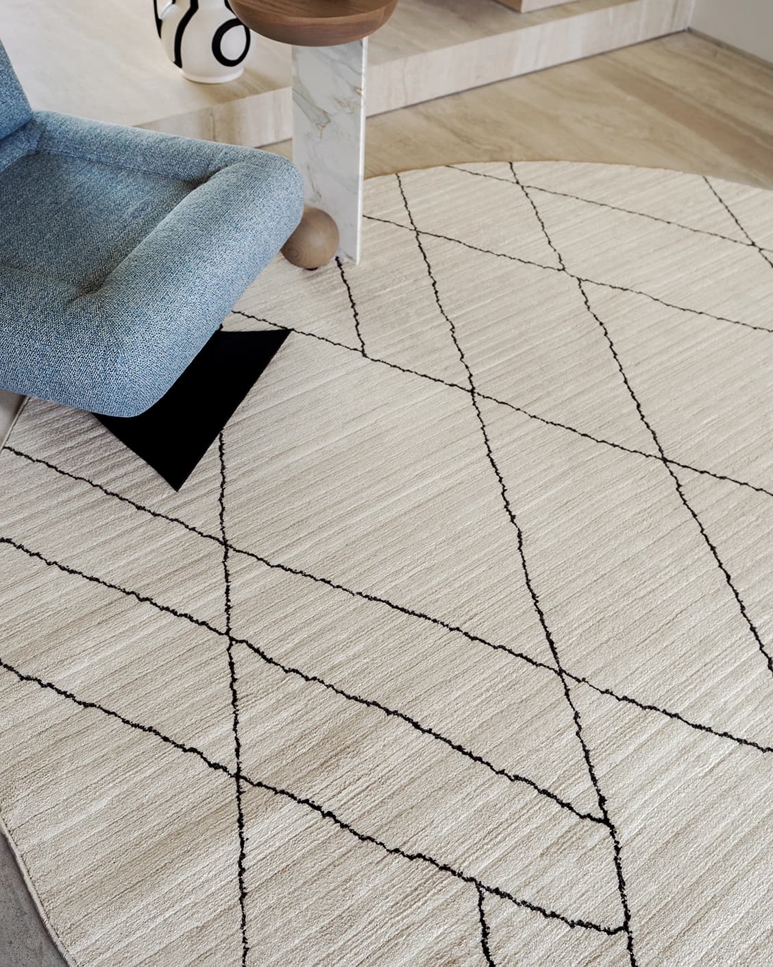 Zen Pearl carpets in charcoal and ivory, shown in a lifestyle close-up top view as image 1
