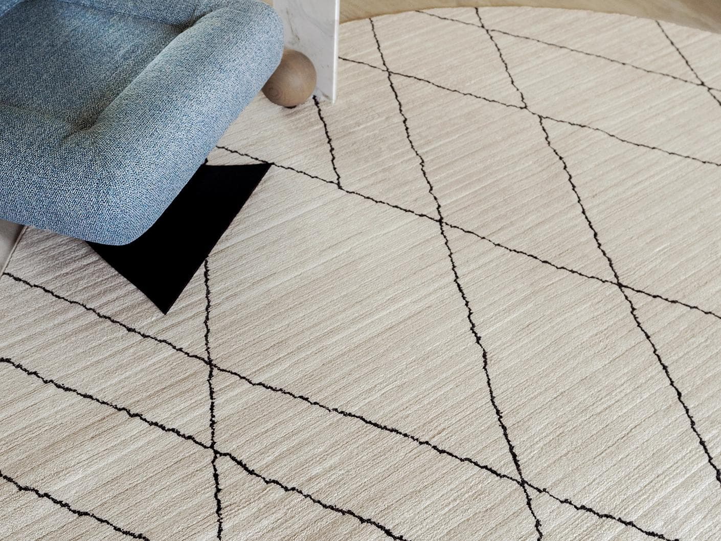Zen Pearl carpets in charcoal and ivory, shown in a lifestyle close-up top view as image 1