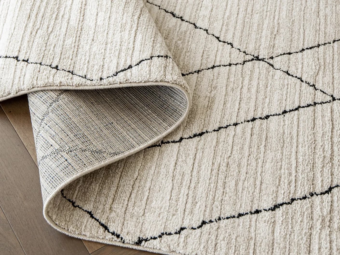 Zen Pearl carpets in pearl, charcoal and ivory, shown in a product close-up view