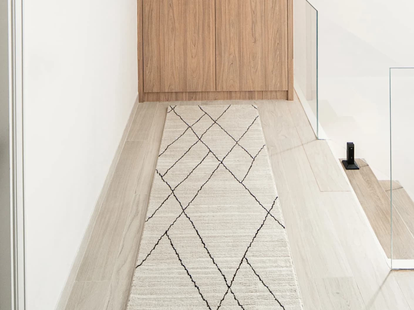 Zen Pearl Runners carpet in charcoal and ivory, shown in a lifestyle front view