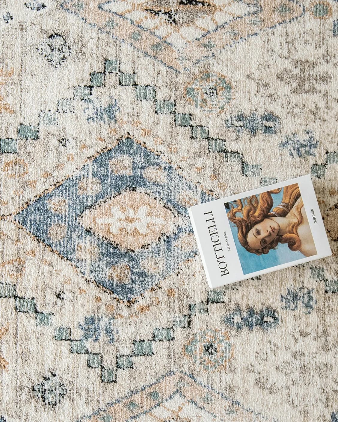 Zen Sandy carpet in beige and blue, shown in a lifestyle top view as image 13