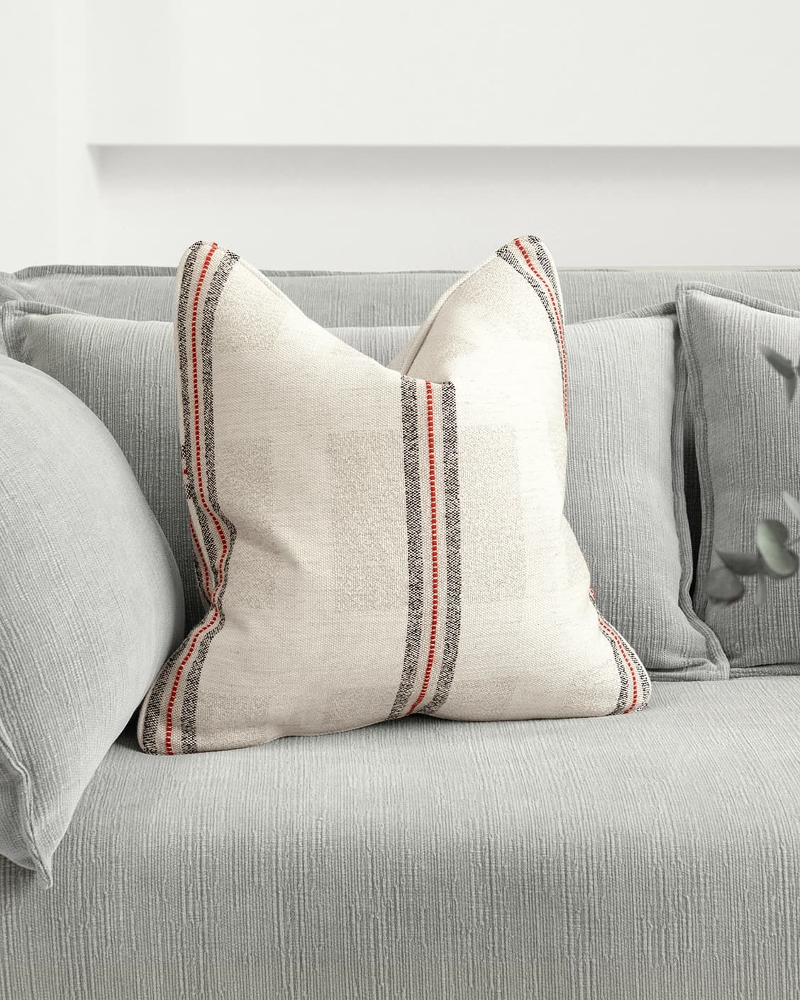 Zia Hodler cushion in multicolour and ivory, shown in a lifestyle front view as image 2