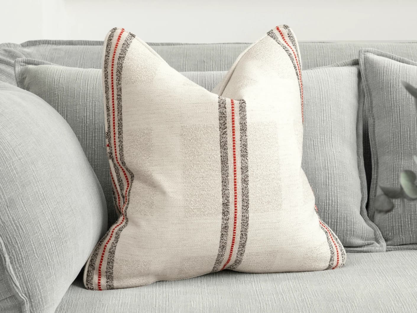 Zia Hodler single cushions in multicolour and ivory, shown in a lifestyle front view