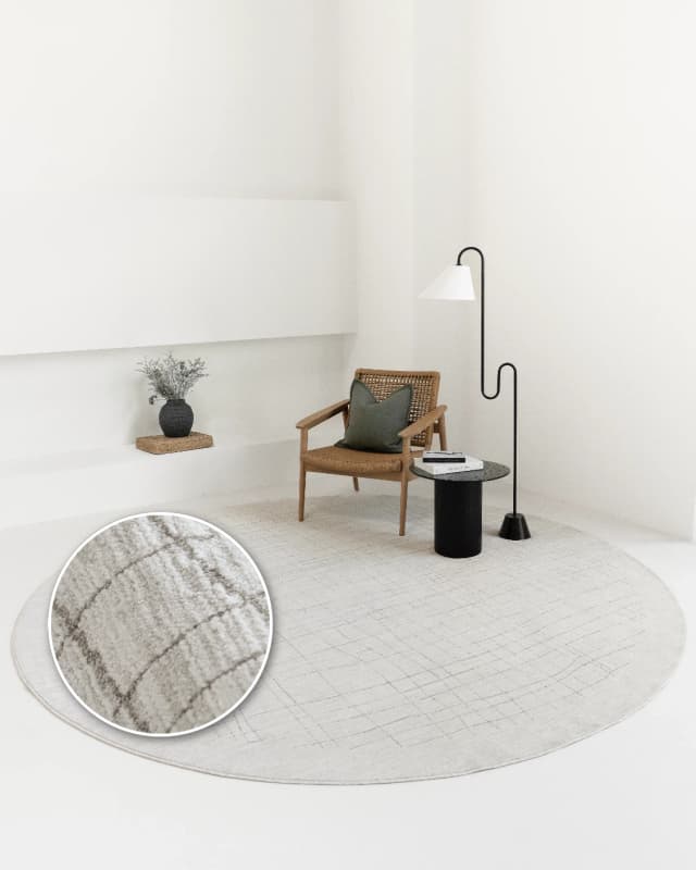Zion Sandy Round carpet in ivory, shown in a lifestyle front view