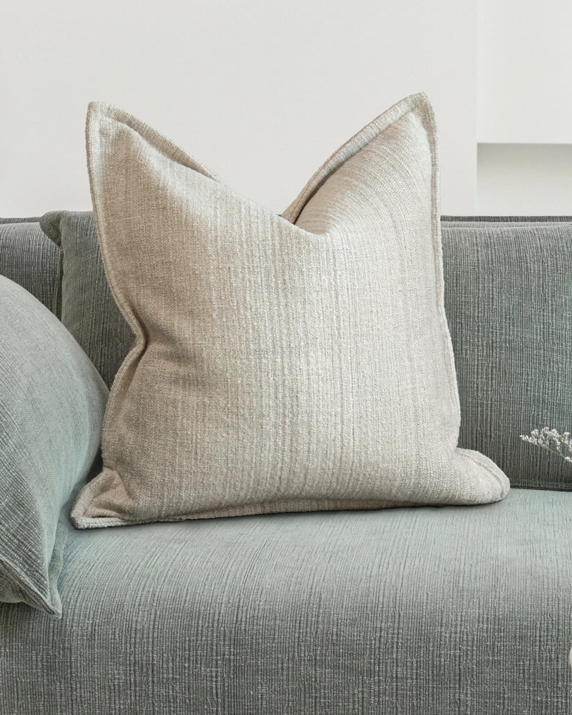 Zoe Laurent cushion in beige, shown in a lifestyle front view as image 2