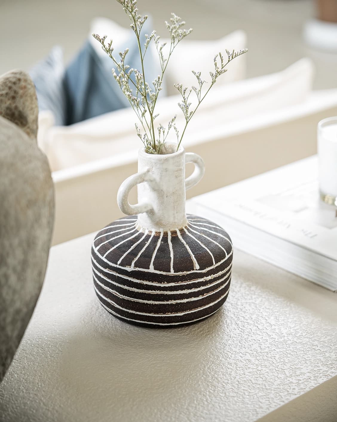 Zyra Terra vases in charcoal black, charcoal and white, shown in a lifestyle right view