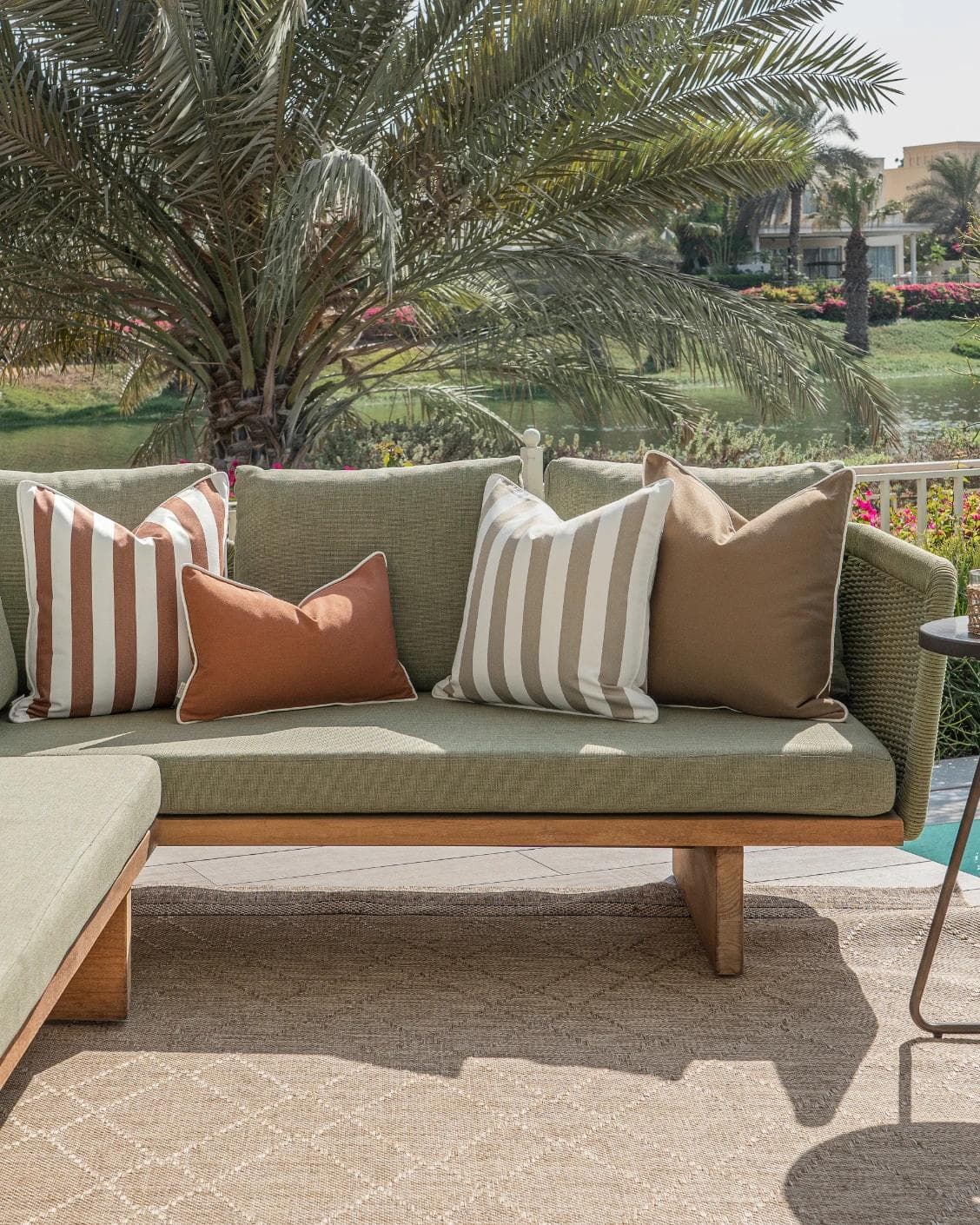 Imani Bundle cushion in brown and rust, shown in a lifestyle front view as image 4