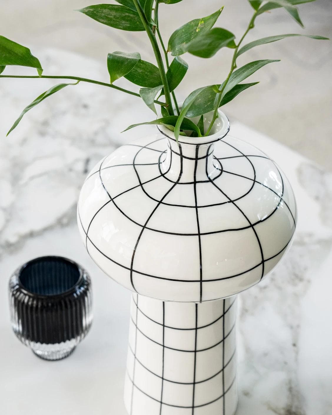 Iris Arneson vases in white and black, shown in a lifestyle top view as image 6