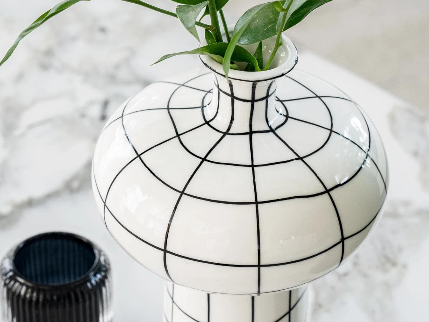 Iris Arneson vases in white and black, shown in a lifestyle top view as image 6