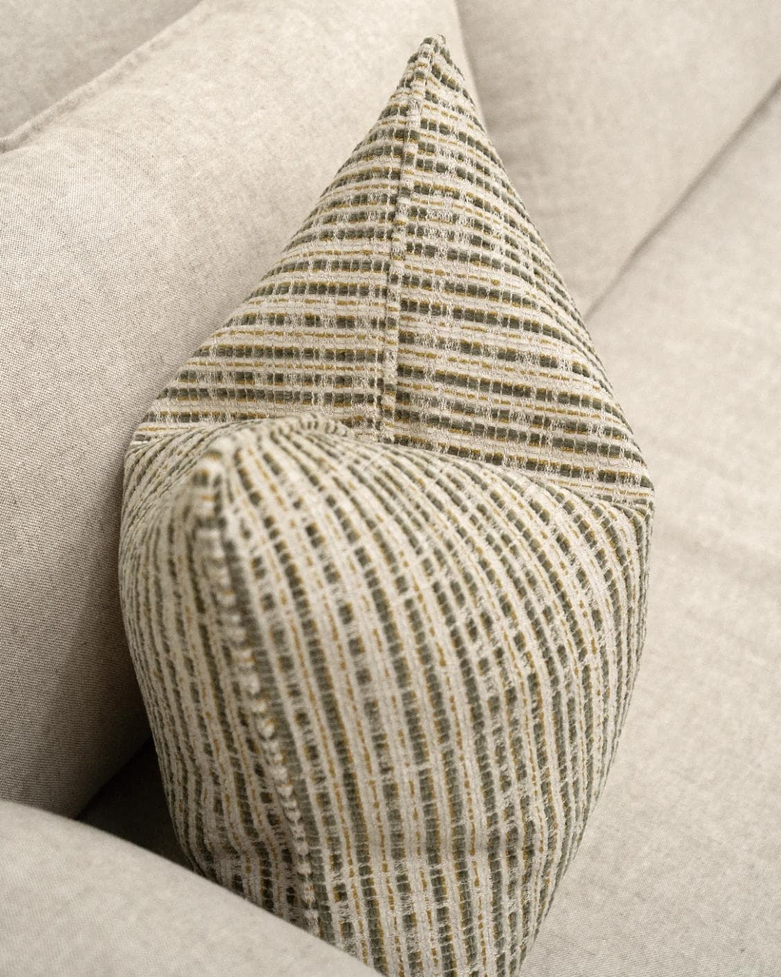 Izzy Olive cushion in ivory, shown in a lifestyle top view as image 5