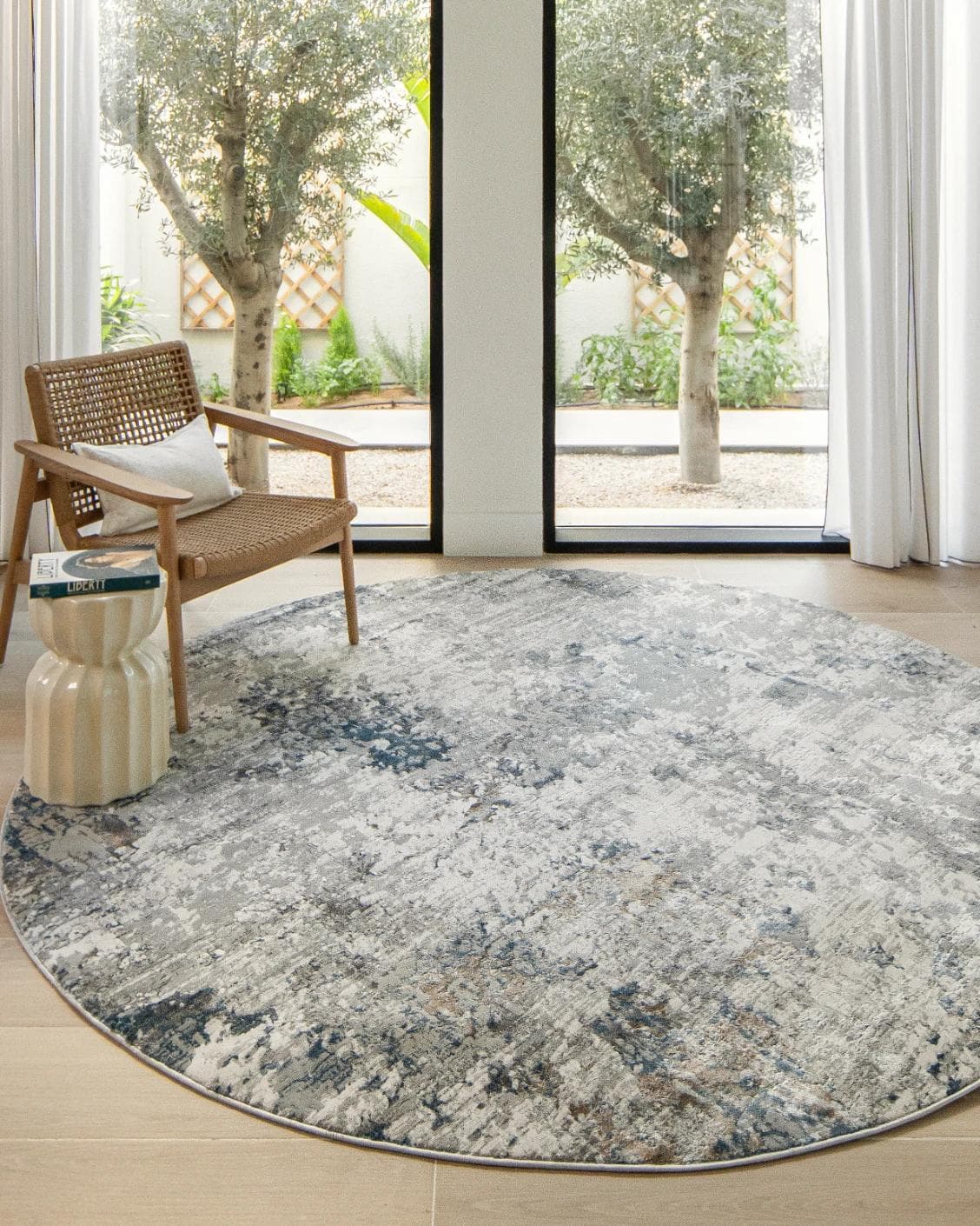 Jacob Sky Round carpet in blue and grey, shown in a lifestyle front view