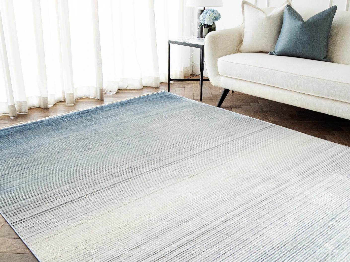 Jade Sky carpet in blue, shown in a lifestyle right view as image 5