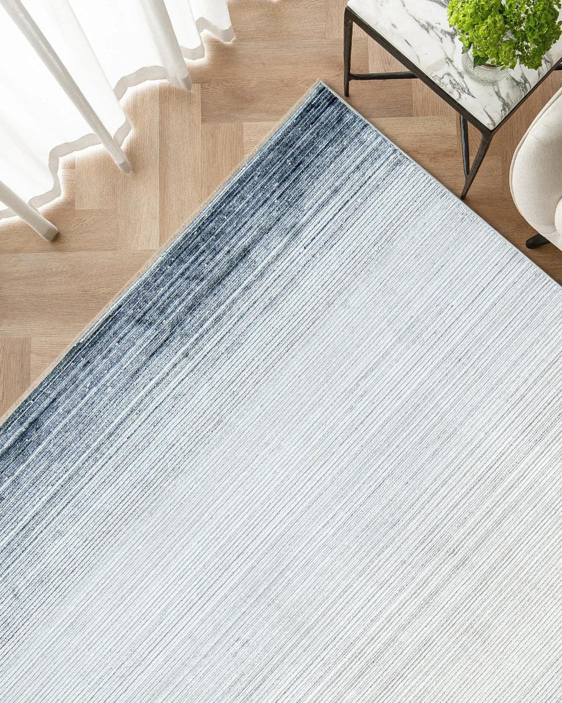 Jade Sky carpet in blue, shown in a lifestyle top view as image 2