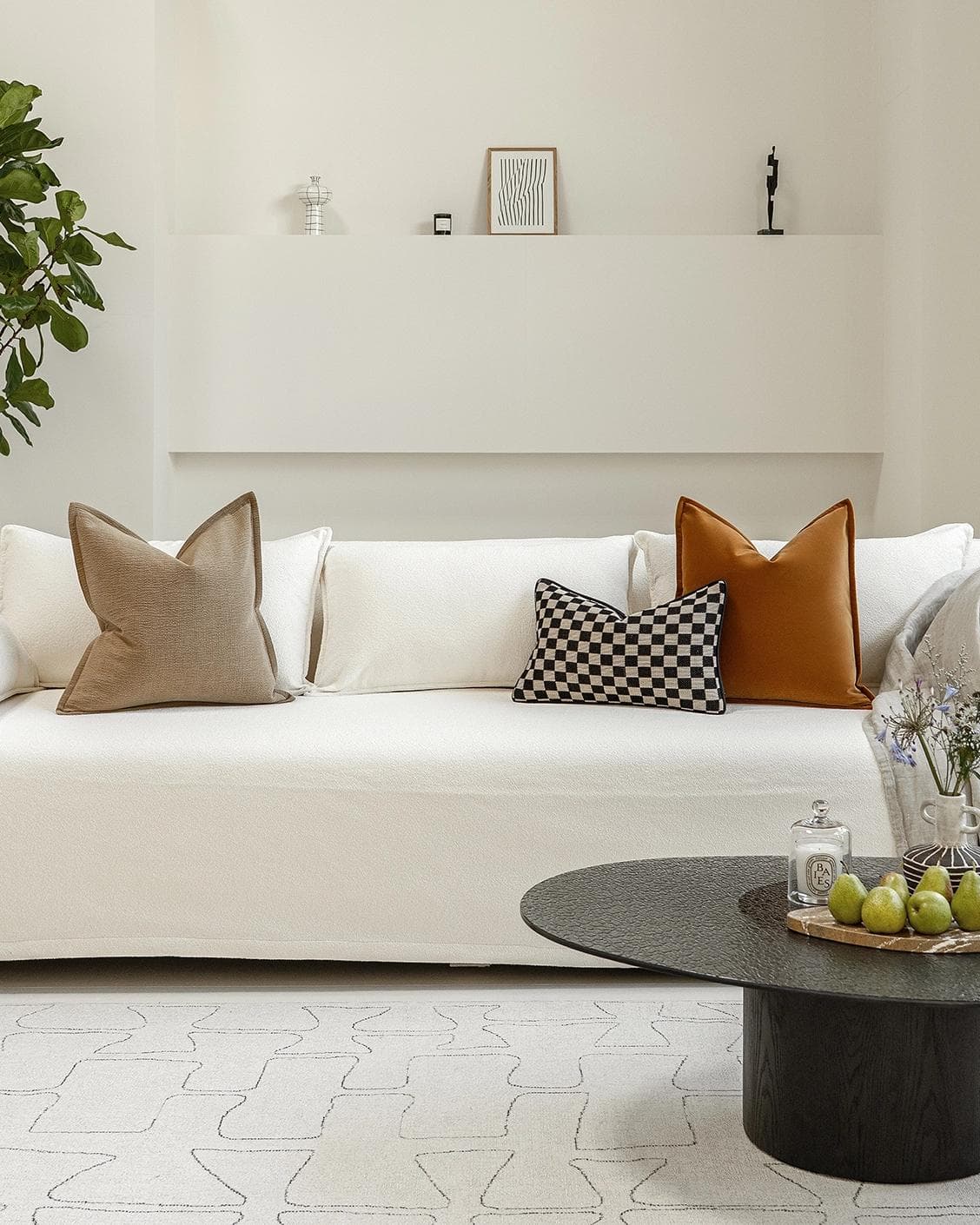 Jancil Bundle cushion in black and orange, shown in a lifestyle front view as image 4