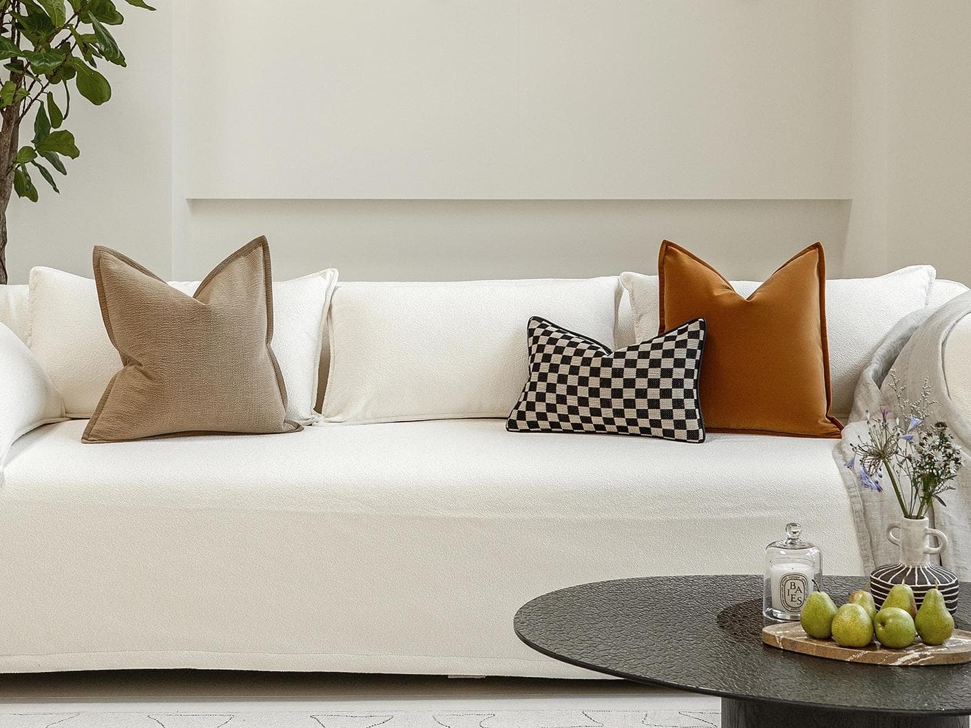 Jancil Bundle cushion in black and orange, shown in a lifestyle front view as image 4