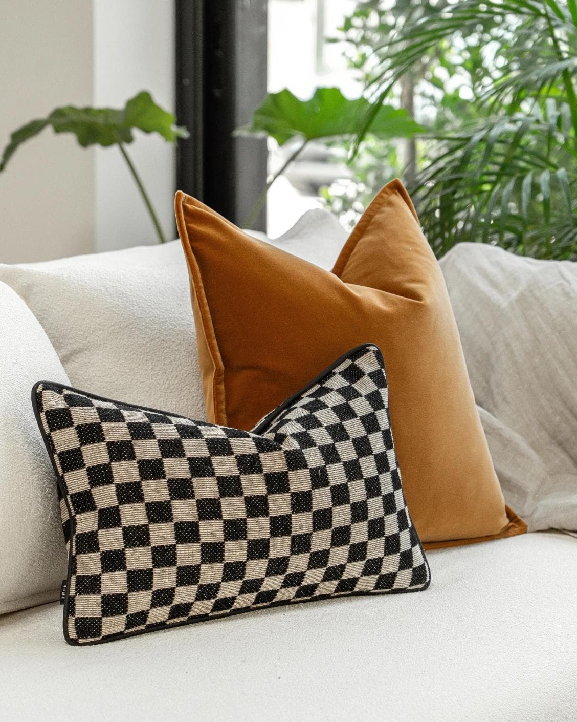 Jancil Bundle cushion in black and orange, shown in a lifestyle left view as image 5