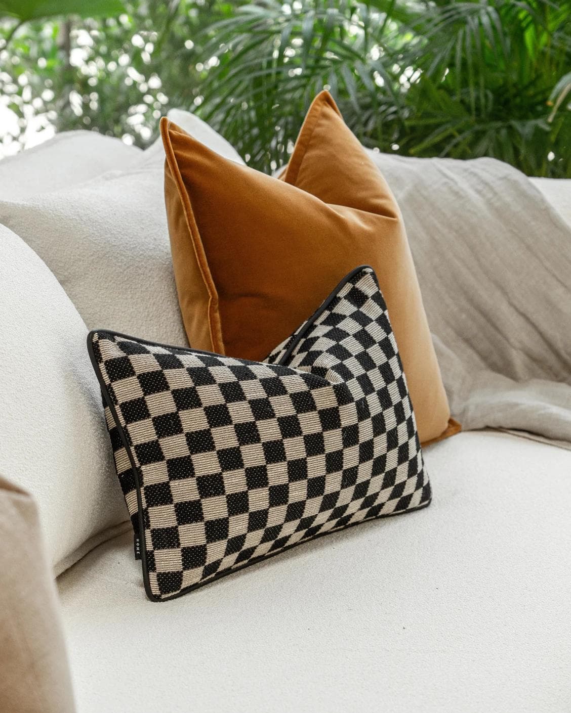 Jancil Bundle cushion in black and orange, shown in a lifestyle left view as image 6