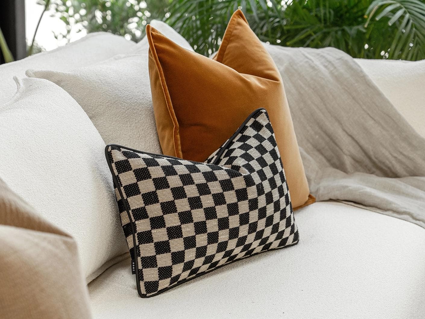 Jancil Bundle cushion in black and orange, shown in a lifestyle left view as image 6