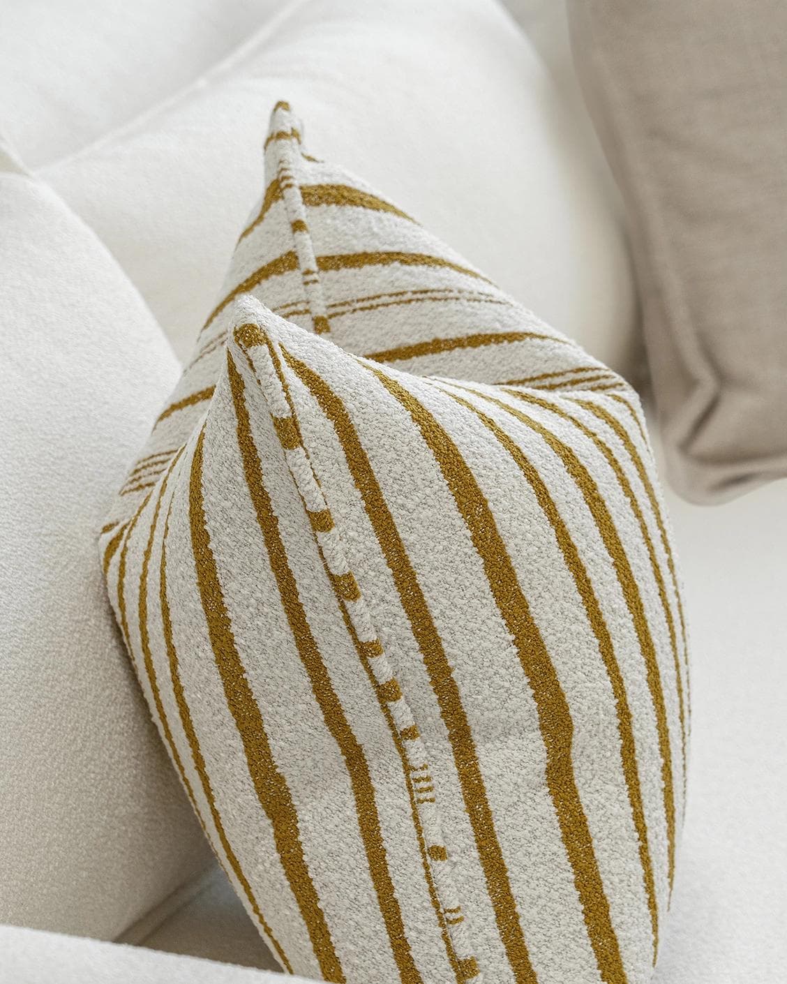 Janina Bundle cushion in beige and cream, shown in a product left view as image 6