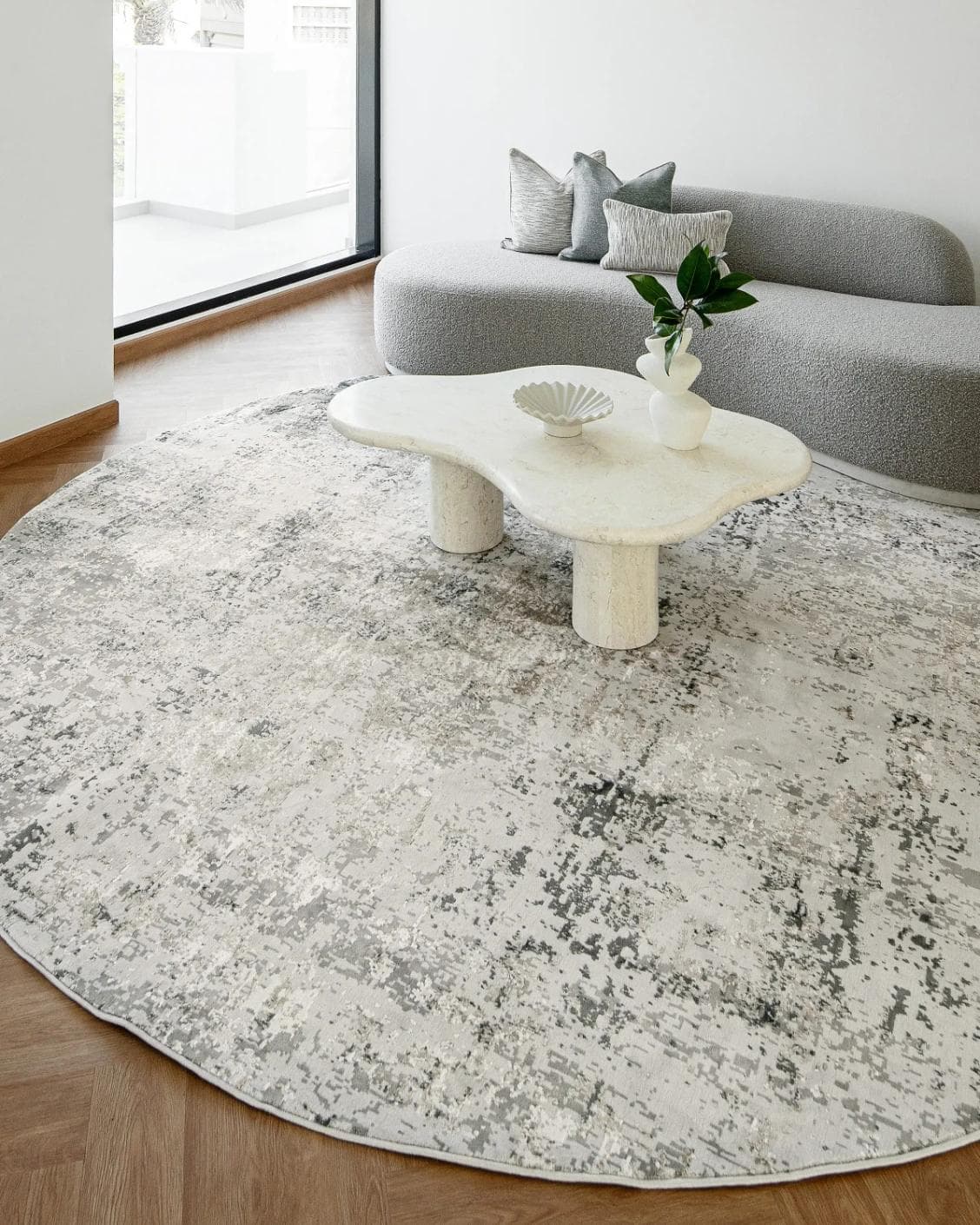 Jay Haywoods Round carpet in grey, shown in a lifestyle front view