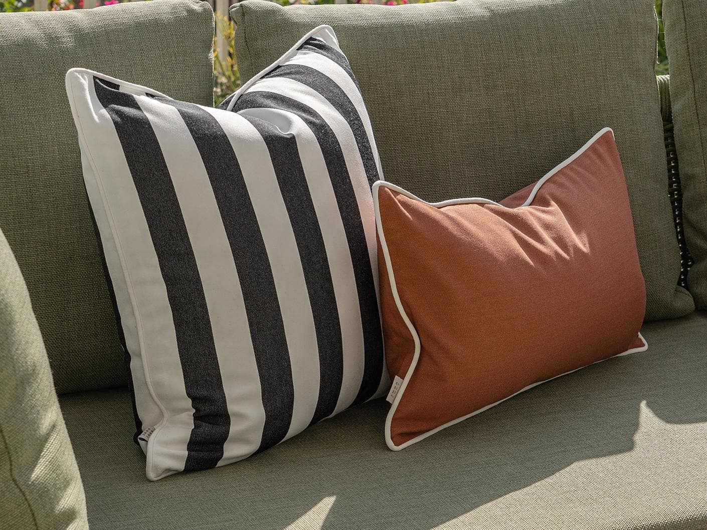 Jival Bundle cushion in black and rust, shown in a lifestyle left view as image 5