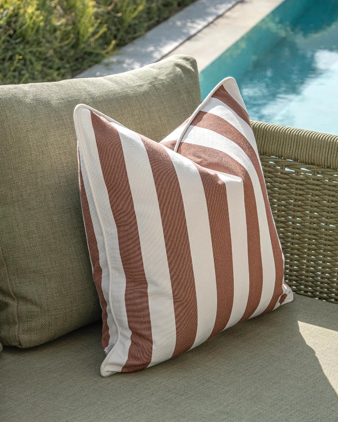 Jival Bundle cushion in black and rust, shown in a lifestyle left view as image 6