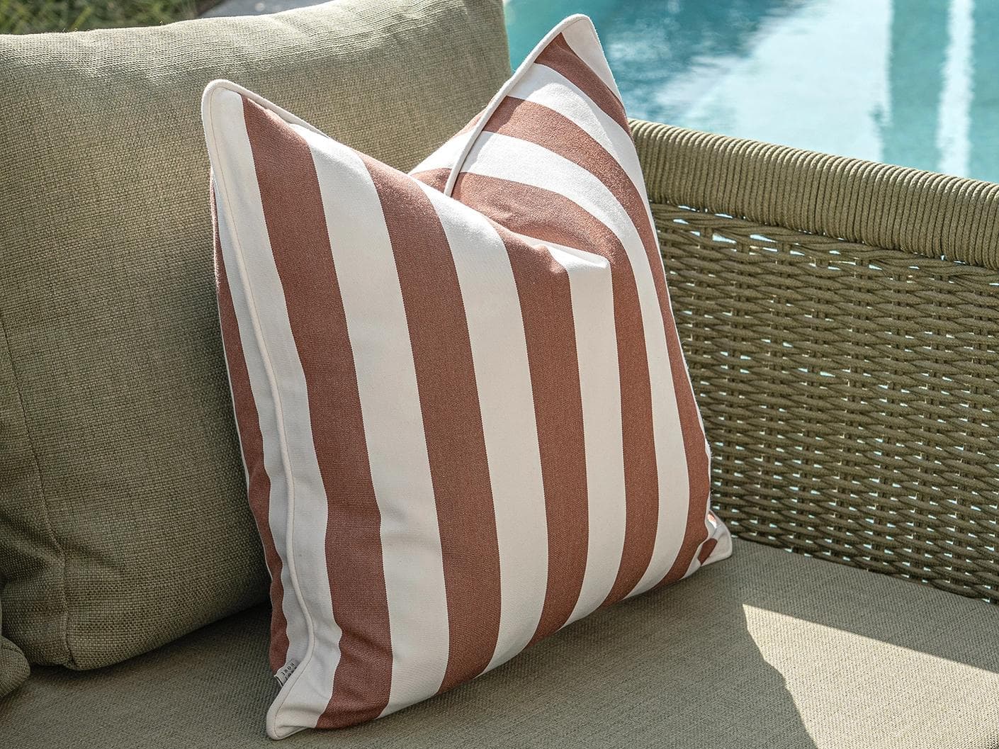 Jival Bundle cushion in black and rust, shown in a lifestyle left view as image 6
