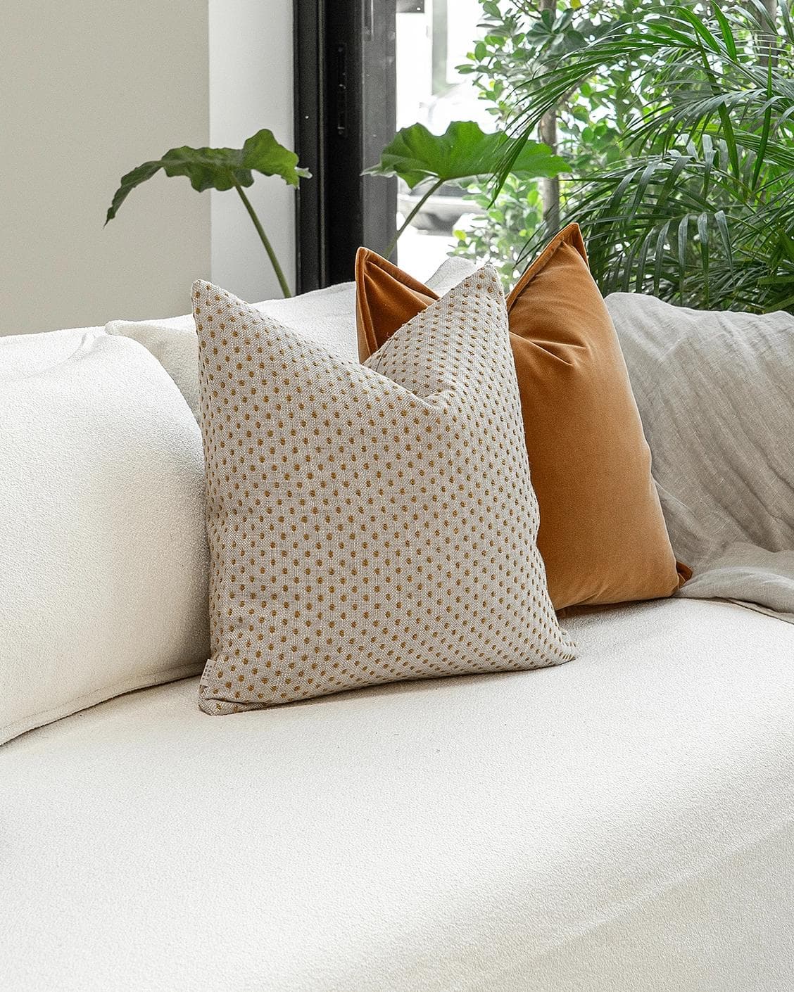 Jolvin Bundle cushion in orange and beige, shown in a lifestyle left view as image 2