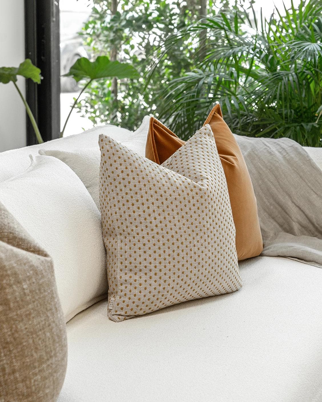 Jolvin Bundle cushion in orange and beige, shown in a lifestyle left view as image 5