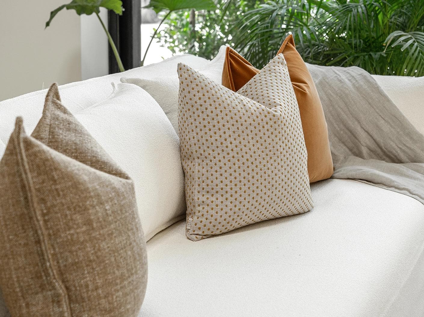 Jolvin Bundle cushion in orange and beige, shown in a lifestyle left view as image 5