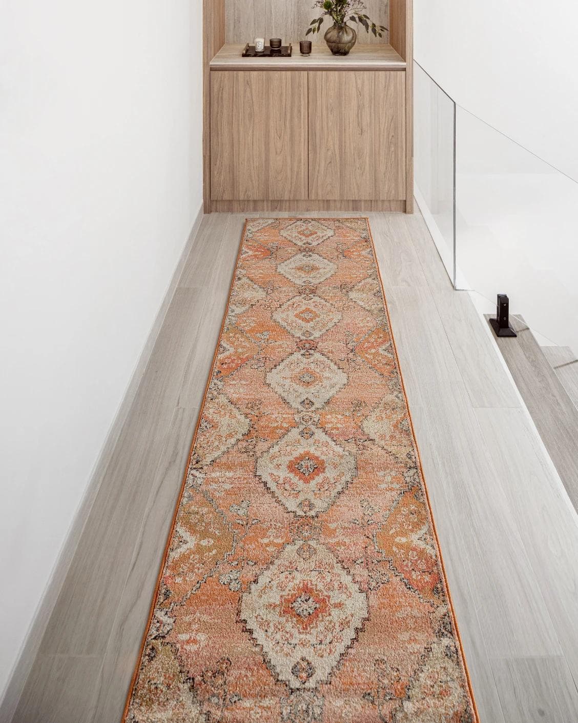 Julian Coral Runners carpet in orange and rust, shown in a lifestyle front view